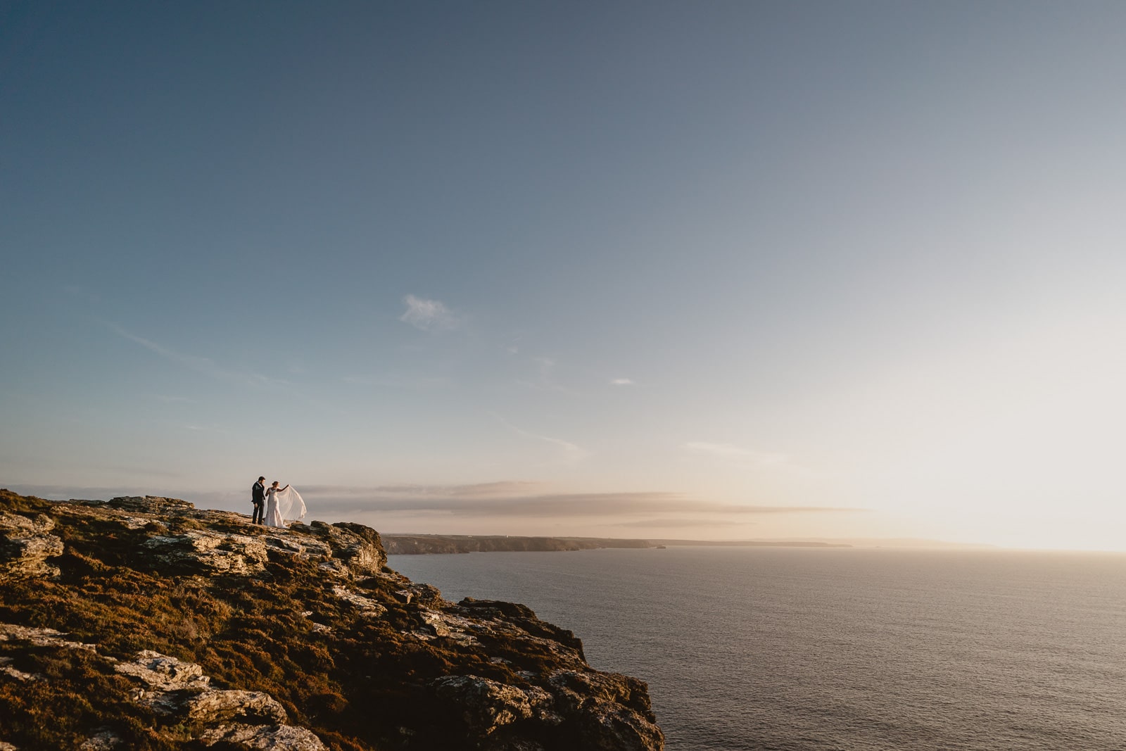 A portrait of a bride and groom on the coastline by Newdowns Farm.